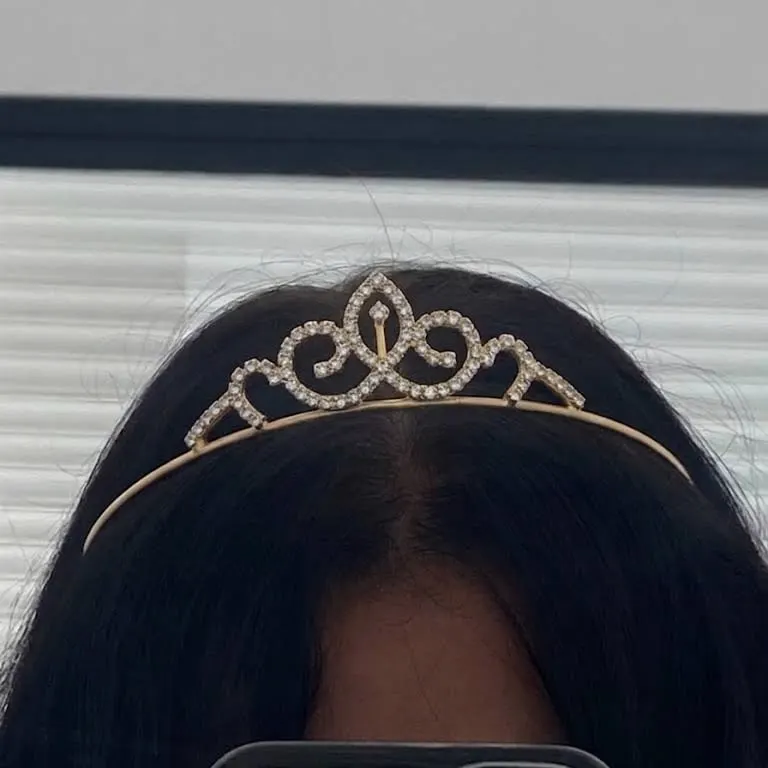 Mini rhinestone tiara worn in dark hair